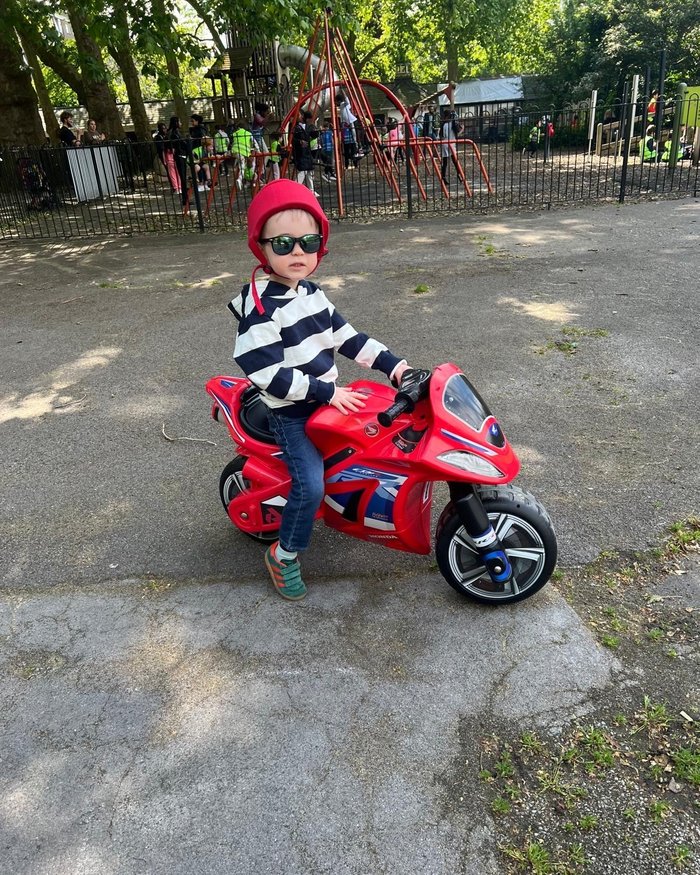 Freddie today, riding his toy motorbike outdoors