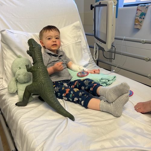 Freddie in his hospital bed with his dinosaur toys