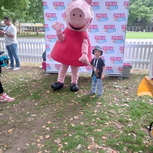 Freddie meeting Peppa Pig at a charity event