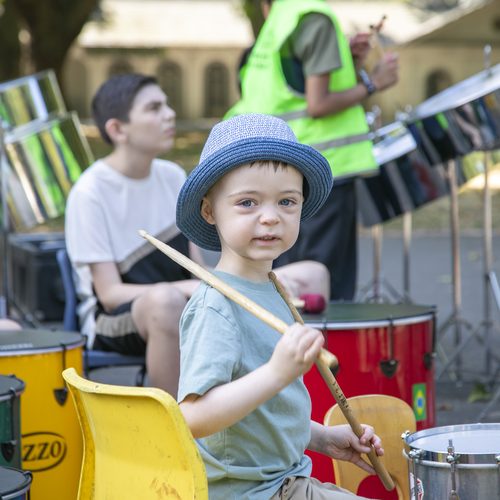 Freddie playing drums at an outdoor carnival event