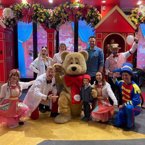 Freddie with costumed characters at Hamleys toy shop