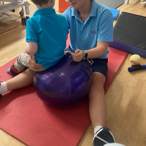 Freddie during a physiotherapy session on an exercise ball
