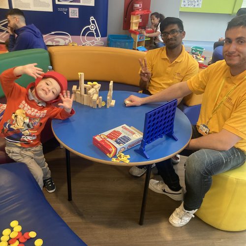 Freddie playing games with hospital volunteers